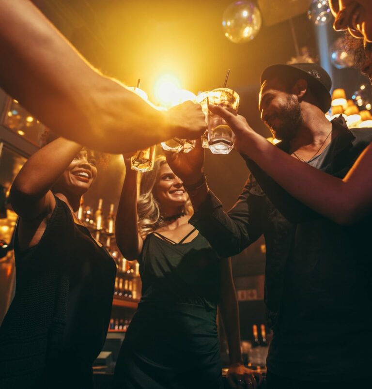 group of friends enjoying drinks at bar